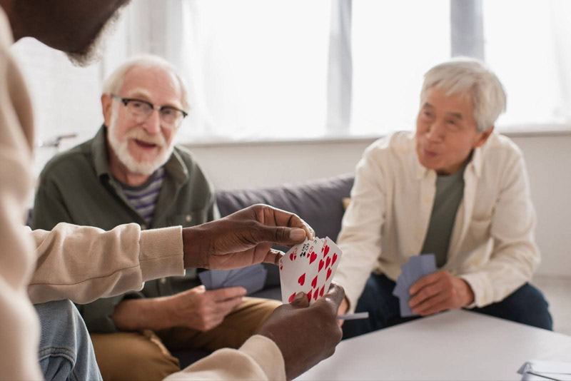 Residents at Village Green 55 plus community in Media Pennsylvania enjoying a card game together in the clubhouse